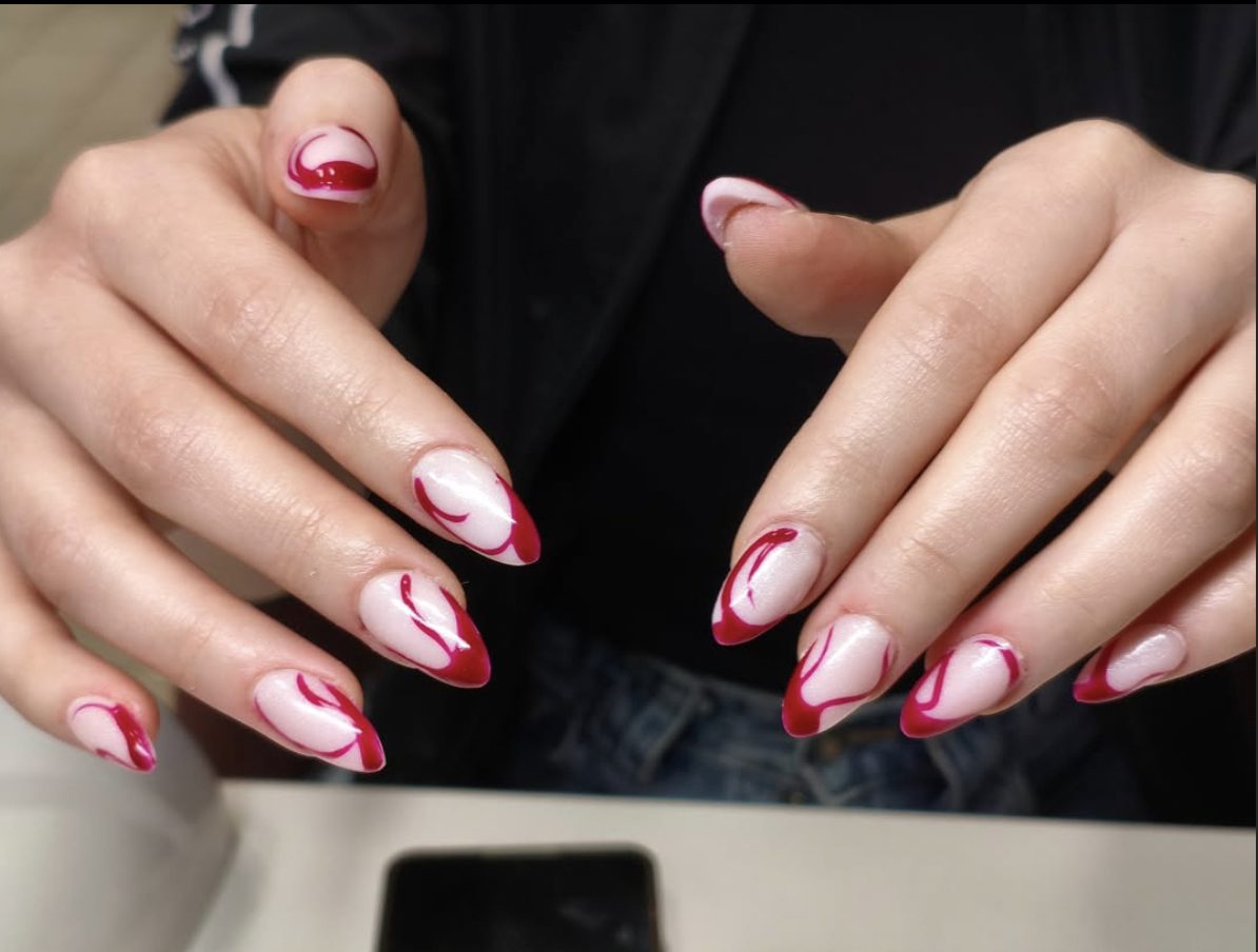 Burgundy swirl French tip almond manicure with abstract nail art